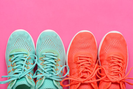 Different stylish sneakers on pink backgroundの写真素材