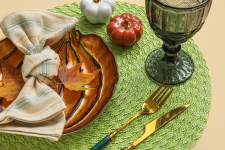Stylish table setting with autumn leaves on beige backgroundの写真素材
