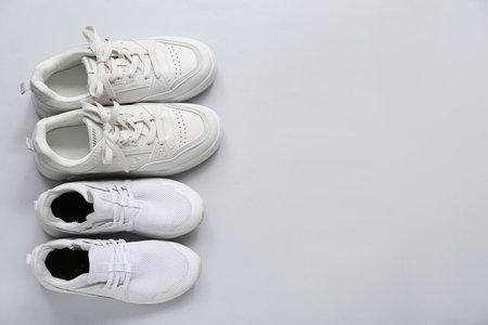 Stylish white sneakers on gray backgroundの写真素材