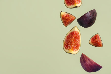 Pieces of fresh ripe figs on green backgroundの写真素材