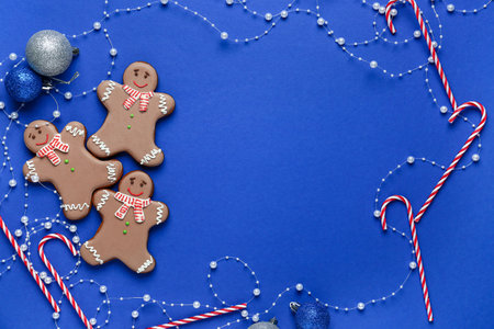 Frame made of gingerbread cookies with Christmas decor on blue backgroundの写真素材