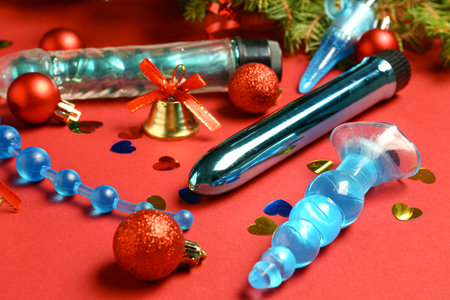 Sex toys with Christmas decor on red backgroundの写真素材