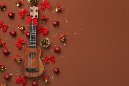 Composition with ukulele and beautiful Christmas decorations on color backgroundの写真素材