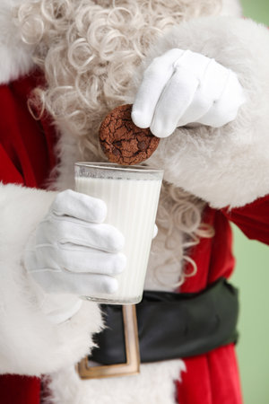 Santa Claus holding glass of milk and cookies, closeupの写真素材