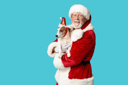 Santa Claus with cute Jack Russell Terrier dog on blue backgroundの写真素材