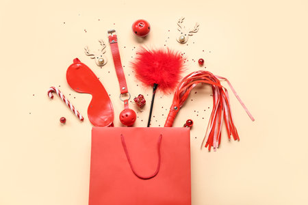 Composition with shopping bag, sex toys and Christmas decorations on color backgroundの写真素材