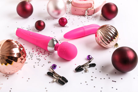 Composition with different sex toys and Christmas decorations on white backgroundの写真素材