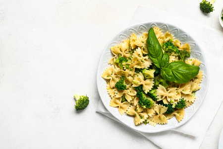 Plate of tasty pasta with broccoli on white backgroundの写真素材