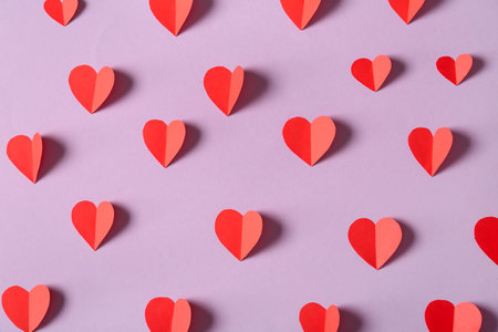 Composition with red paper hearts on pink background. Valentines Day celebrationの写真素材