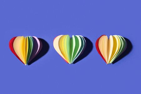Composition with colorful paper hearts on blue background. Valentines Day celebrationの写真素材