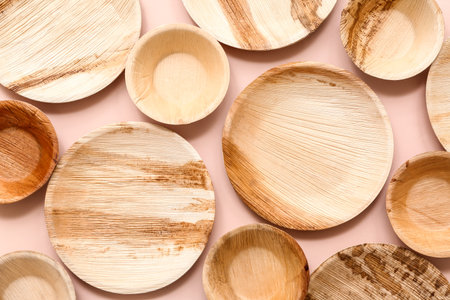 Disposable eco plates on pink background