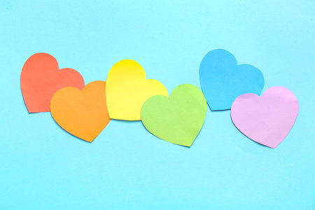 Colorful paper hearts on blue background. LGBT conceptの写真素材