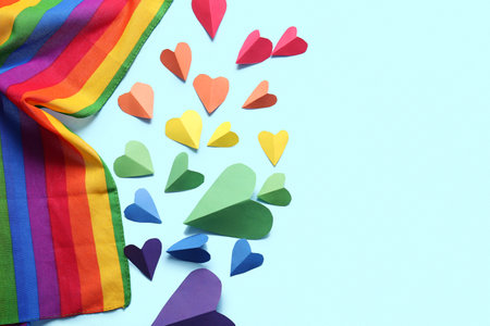 Colorful paper hearts and LGBT flag on blue background. LGBT conceptの写真素材