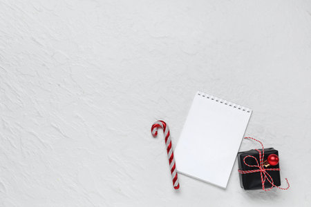 Blank paper calendar, gift box and candy cane on white backgroundの写真素材