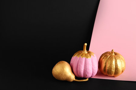 Painted pumpkins with golden pear on colorful backgroundの写真素材