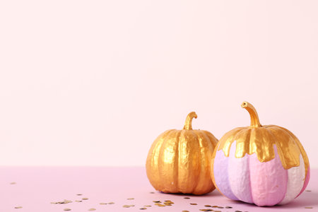 Different painted pumpkins and confetti on colorful backgroundの写真素材