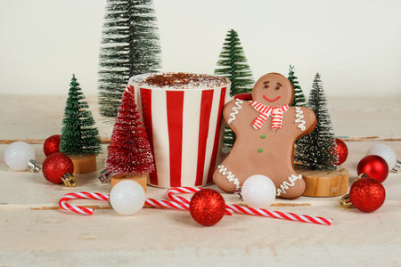 Composition with cup of cocoa drink, beautiful Christmas decorations and cookies on light wooden...