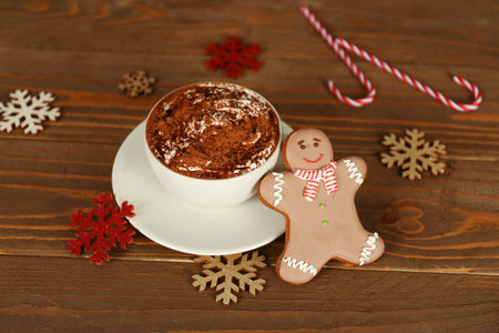 Cup of tasty cocoa drink, Christmas cookies and decorations on wooden table