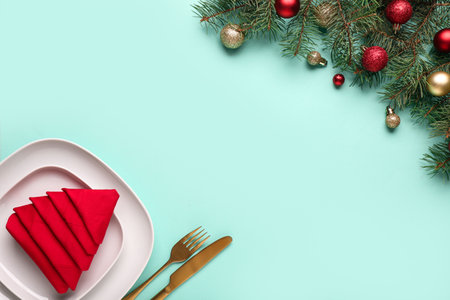 Beautiful table setting for Christmas dinner on turquoise backgroundの写真素材