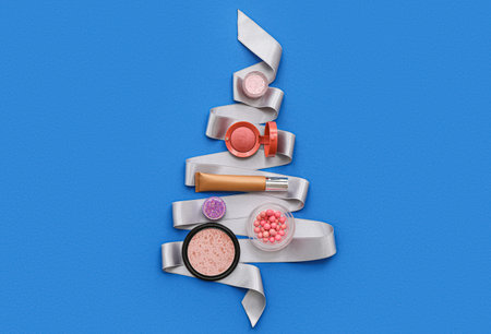 Different decorative cosmetics and Christmas decor on blue backgroundの写真素材