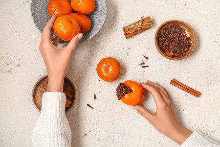 Woman decorating pomander balls on white backgroundの写真素材