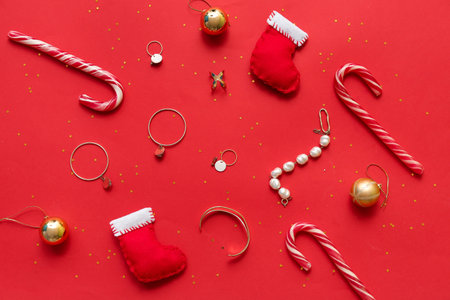 Christmas composition with jewelry and decor on red background