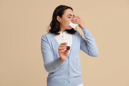 Sick young woman on beige backgroundの写真素材