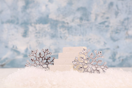 Decorative snow with snowflakes and plaster podium on blue grunge backgroundの写真素材
