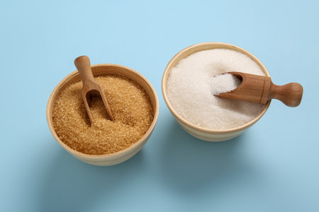 Bowls with different types of sugar on blue backgroundの写真素材