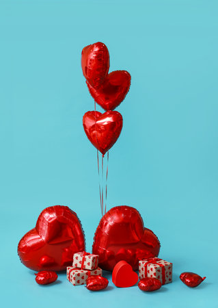 Heart shaped air balloons and gift boxes on blue backgroundの写真素材