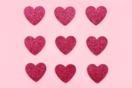 Glitter hearts on pink backgroundの写真素材