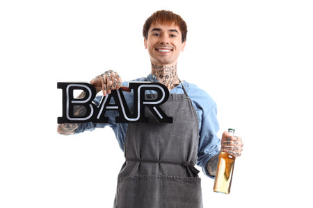 Young male bartender with bottle of beer and word BAR on white backgroundの写真素材