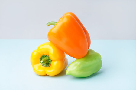 Fresh bell peppers on blue background