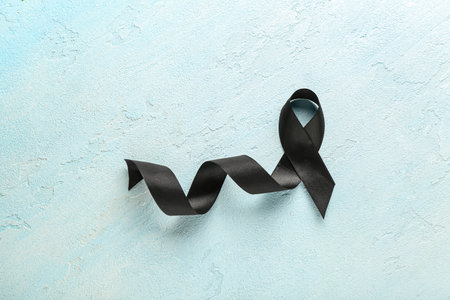 Black funeral ribbon on blue backgroundの写真素材