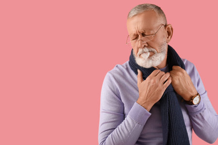 Sick mature man on pink background