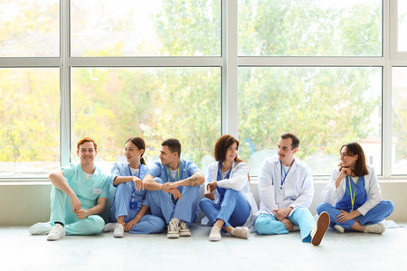 Team of doctors sitting in hall of clinicの写真素材
