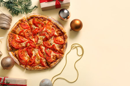 Delicious pizza with Christmas decor on beige backgroundの写真素材