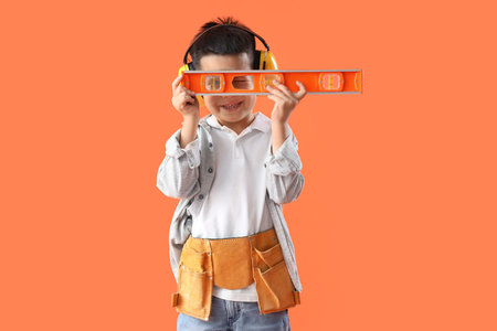 Cute little worker with level on orange background