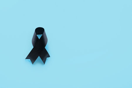 Black funeral ribbon on blue backgroundの写真素材