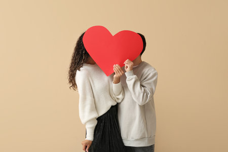 Couple with red heart for Valentine's day on beige backgroundの写真素材