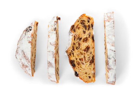 Slices of tasty Christmas stollen on white backgroundの写真素材