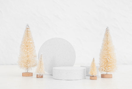 Decorative Christmas trees with plaster podiums on white grunge backgroundの写真素材