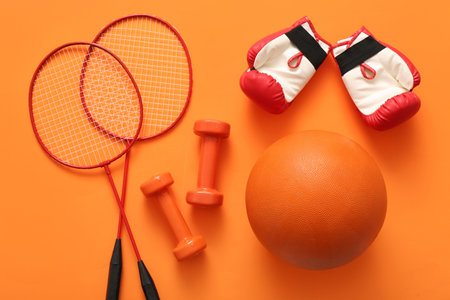 Set of sports equipment on orange backgroundの写真素材