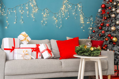 Stylish interior of living room with gifts and Christmas treeの写真素材