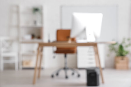 Blurred view of office with workplaceの写真素材