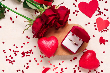 Beautiful composition with engagement ring and rose flowers on white background. Valentine's day...