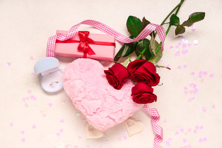 Beautiful composition with engagement ring and rose flowers on white background. Valentine's day celebrationの写真素材