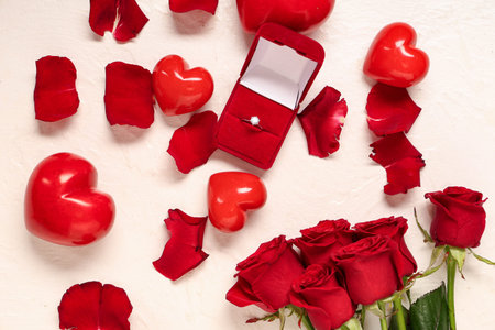 Beautiful composition with engagement ring and rose flowers on white background. Valentine's day...