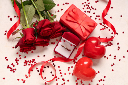 Beautiful composition with engagement ring and rose flowers on white background. Valentine's day...