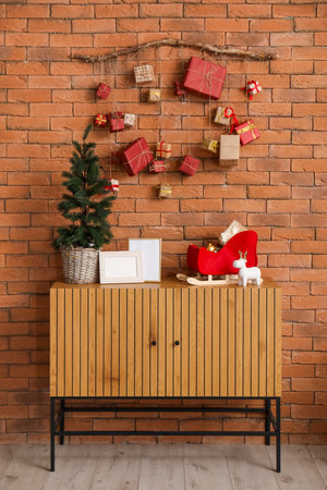 Christmas advent calendar hanging on brick wall in roomの写真素材